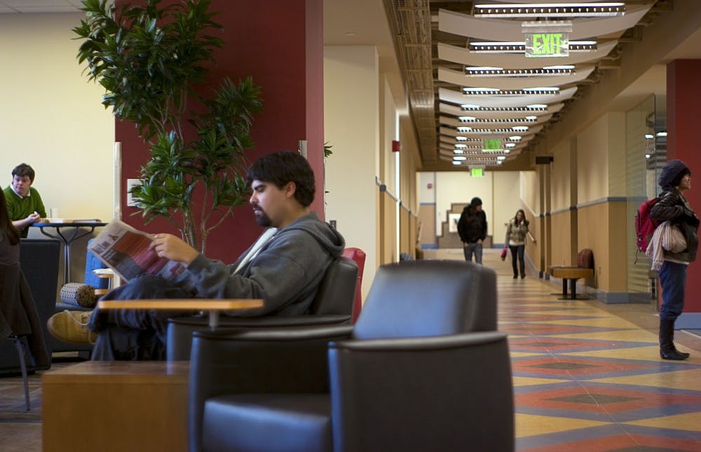 	Daniel Balderston reads the Daily Lobo in one of the new lounges in Mitchell Hall on Tuesday. The renovated classroom building now offers additional seating areas new interior, upgraded bathrooms and an Outtake’s Deli.