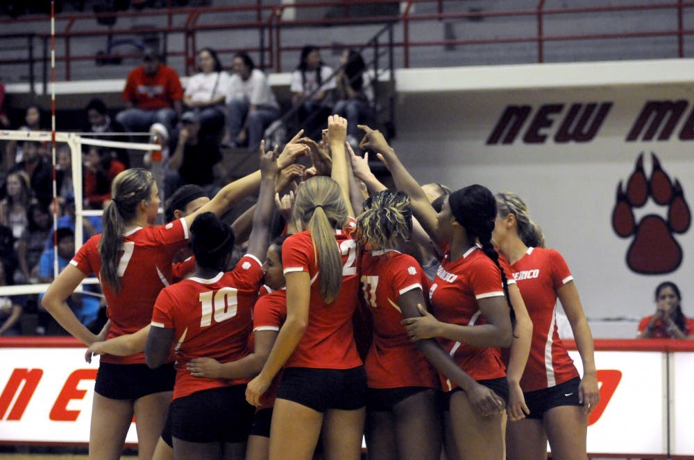 The New Mexico volleyball players reach in for a team huddle during a match last season. The Lobos open their season at the Ball State Active Ankle Challenge.