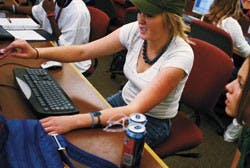 UNM freshman Memi Moore takes a psychology quiz for class online in the SUB computer lab Thursday.  