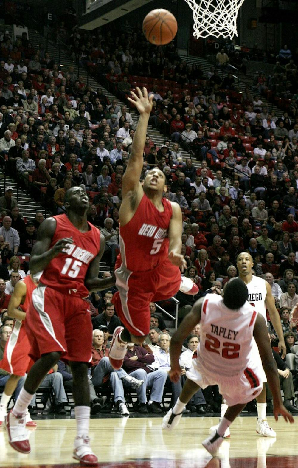 	UNM guard Dairese Gary jumping over SDSU guard Chase Tapley at the game on Tuesday at Viejas Arena, San Diego. Lobos lost the game 74-64.