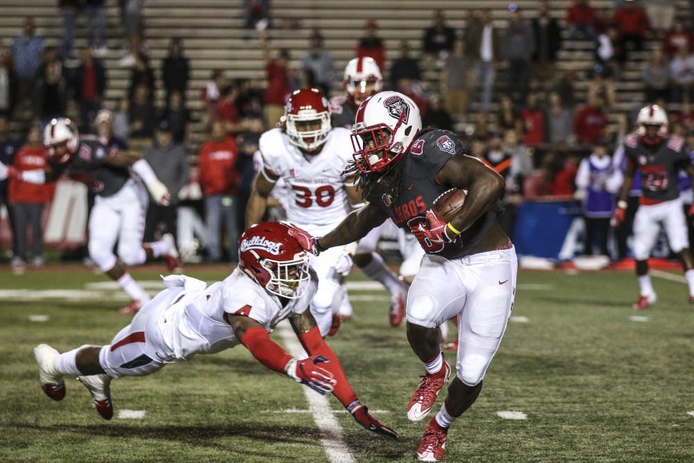 De’John Rogers (#6) stiff-arms an on-coming tackler from Fresno State during Saturday’s game. UNM was defeated 38-7. &nbsp;