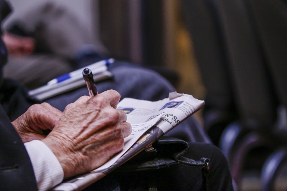 A free speech panel attendee takes notes during the panel discussion Wednesday, Jan. 25, 2017 at the SUB Atrium.&nbsp;
