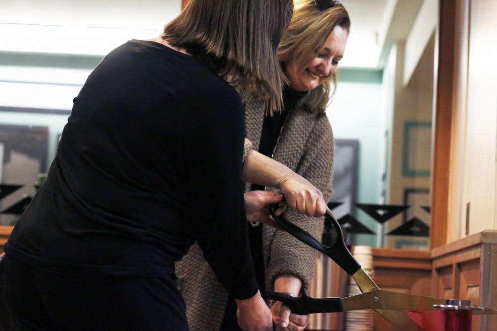 GPSA President&nbsp;Texanna Martin helps Hilary Wainwright cut the ribbon for a new study room exclusively&nbsp;for graduates in Zimmerman Library. The space was supported by the New Mexico Legislature and Gov. Susanna&nbsp;Martinez to ensure graduate success.&nbsp;