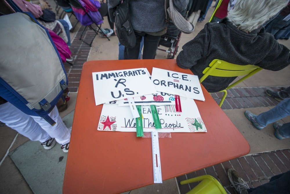 Signs lay on a table as part of a anti-ICE rally on Tuesday, Feb. 21, 2017 in downtown Albuquerque, New Mexico. Dreamers who are  part of the DACA act have raised concerns due to the current political climate. 
