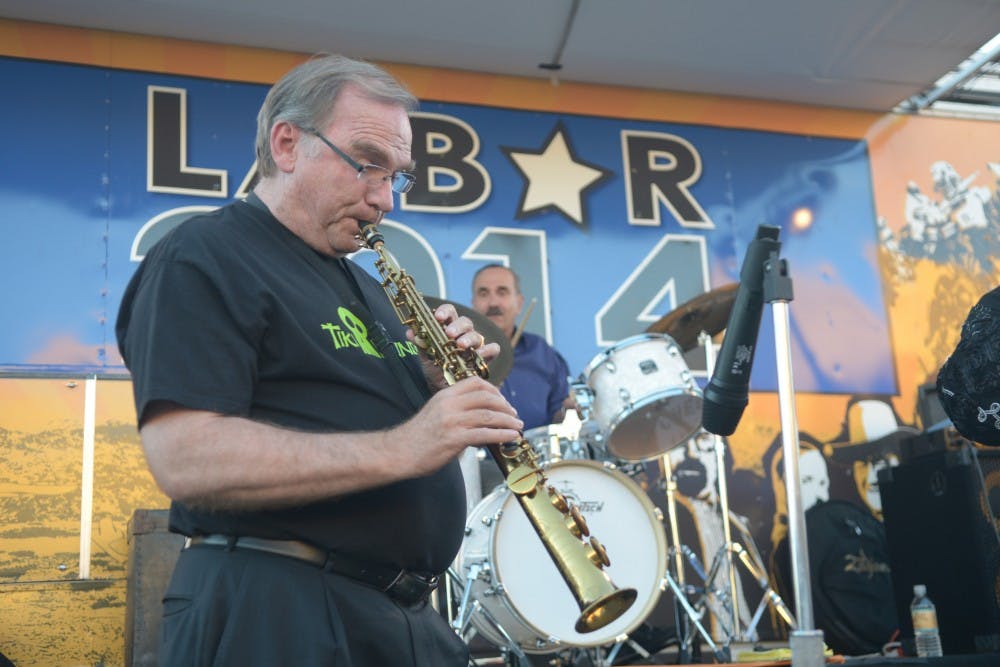 New Mexico Attorney General Gary King plays a saxophone during a Labor Day Event at Tractor Brewing in Downtown Albuquerque on Sept. 1, 2014. King, a Democrat, is running against incumbent Gov. Susana Martinez in the upcoming election.