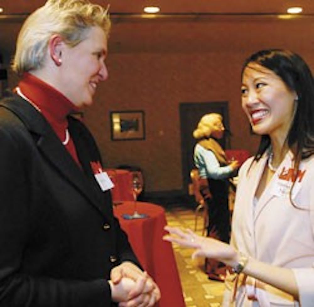 UNM presidential candidate Meredith Hay, left, talks with Student Regent Rosalyn Nguyen after a reception at the Albuquerque Hilton on Thursday. 