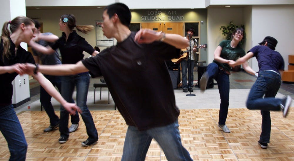	Couples swing dance in the SUB Atrium on Wednesday. Students organized the Peace Fair with dancing, yoga and panel discussions all day.