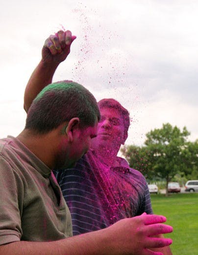 Ashwin Navaday throws paint at Maheshwar Reddy Kashamolla during  the India Students Association's Holi festival Saturday at Johnson Field. 