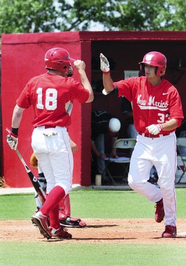 Max Willett congratulates Ryan Honeycutt after he smoked a two-run homer in Sunday's 13-11 loss to UNLV in extra innings at Lobo Field. The Runnin' Rebels took the series 2-1.