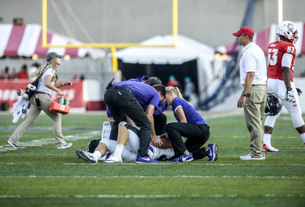 Abilene Christian University head coach Adam Dorrel and athletic trainers tend to downed Sam Denmark of Las Cruces, New Mexico during the Lobos vs. Wildcats game Saturday, Sept. 2, 2017.