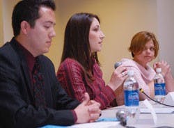 ASUNM presidential candidate Ashley Fate, center, explains her goals if elected president while candidates Katryn Fraher, right, and Louis Jeantete listen during a debate Monday in the SUB.