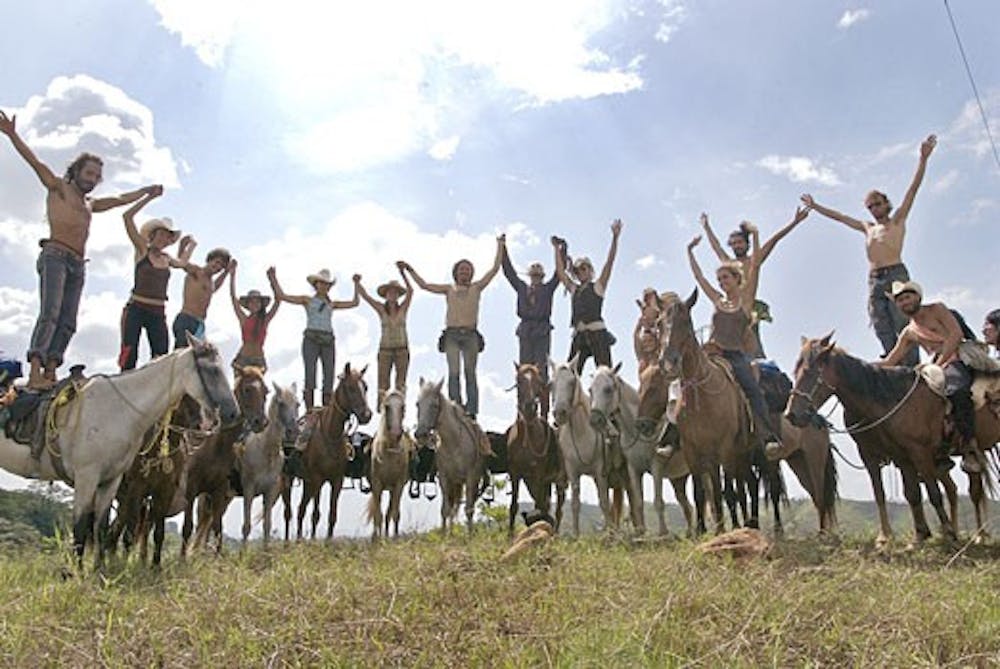 Attendees of the Rainbow Gathering celebrate their community experience in Fallsville, Arkansas in July 2007. The Rainbow Gathering will be held in the Santa Fe National Forest July 1-7. 