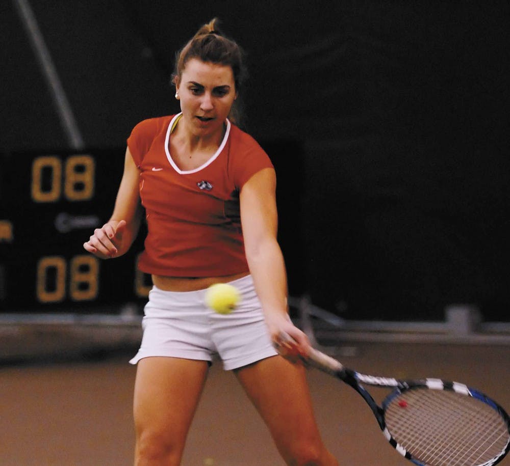 Sophomore Mackenzie White hits a forehand during practice at the UNM Tennis Complex on Thursday.