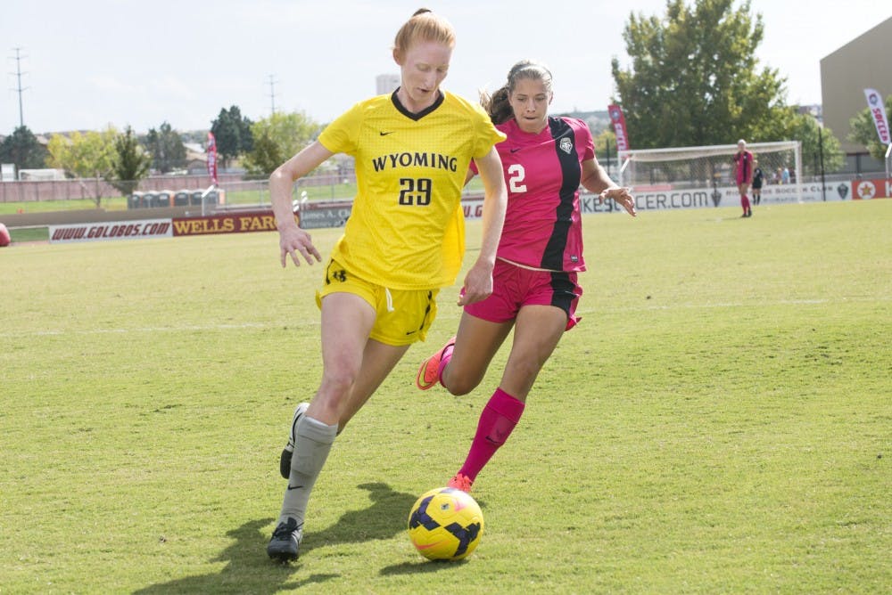 New Mexico midfielder Katie Hinman, right, and Wyoming midfielder Kasey Curtis battle for possession of the ball during the game on Sunday at the Lobo Soccer Complex. The Lobos defeated the cowgirls 2-1, scoring both of their goals in the second half of the game.