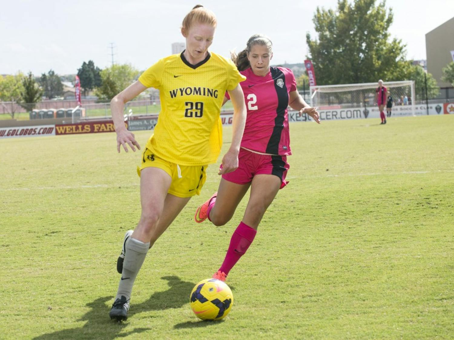 New Mexico midfielder Katie Hinman, right, and Wyoming midfielder Kasey Curtis battle for possession of the ball during the game on Sunday at the Lobo Soccer Complex. The Lobos defeated the cowgirls 2-1, scoring both of their goals in the second half of the game.