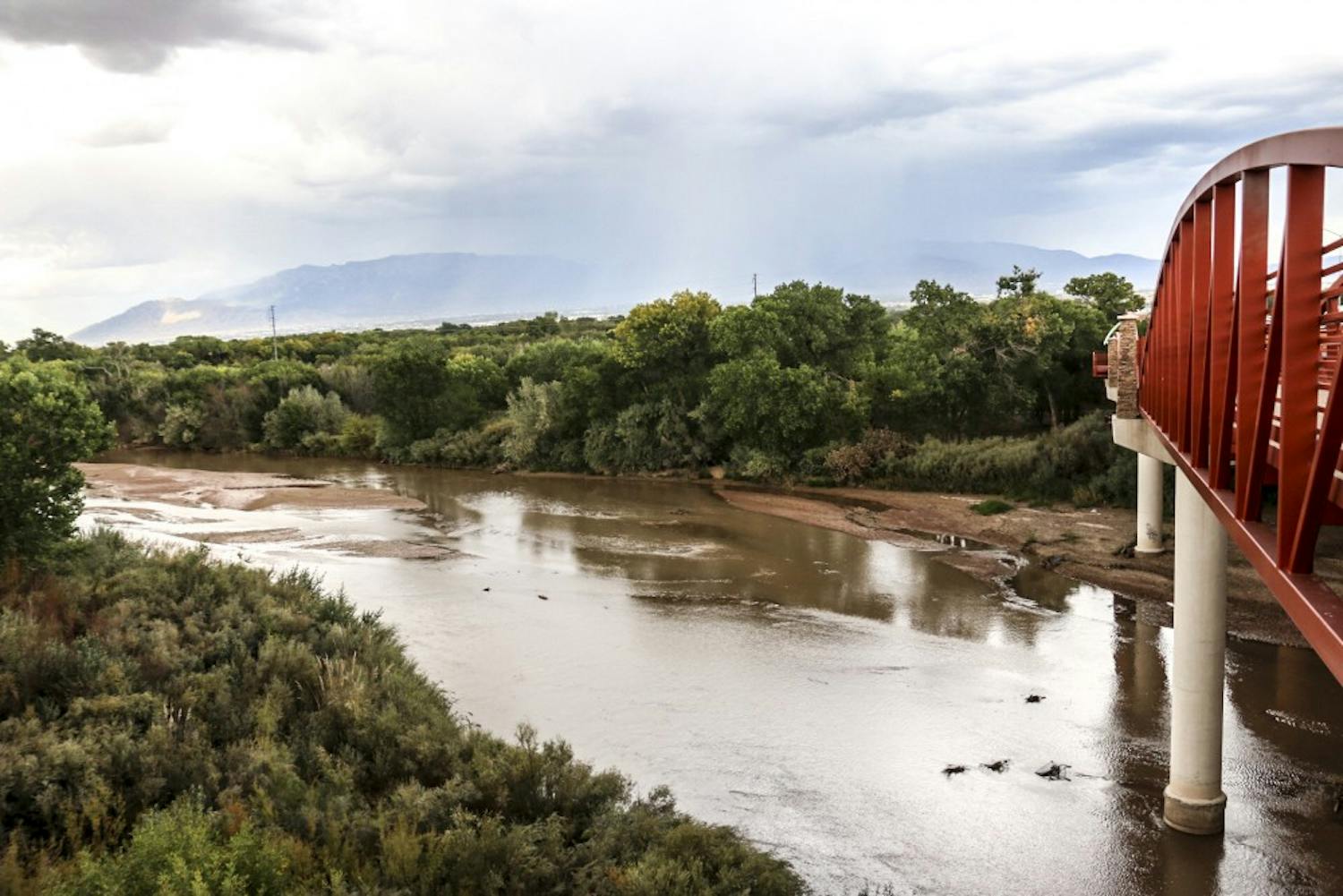 The Rio Grande River flows as storm settles over Albuquerque on the afternoon of Sept. 19, 2018.