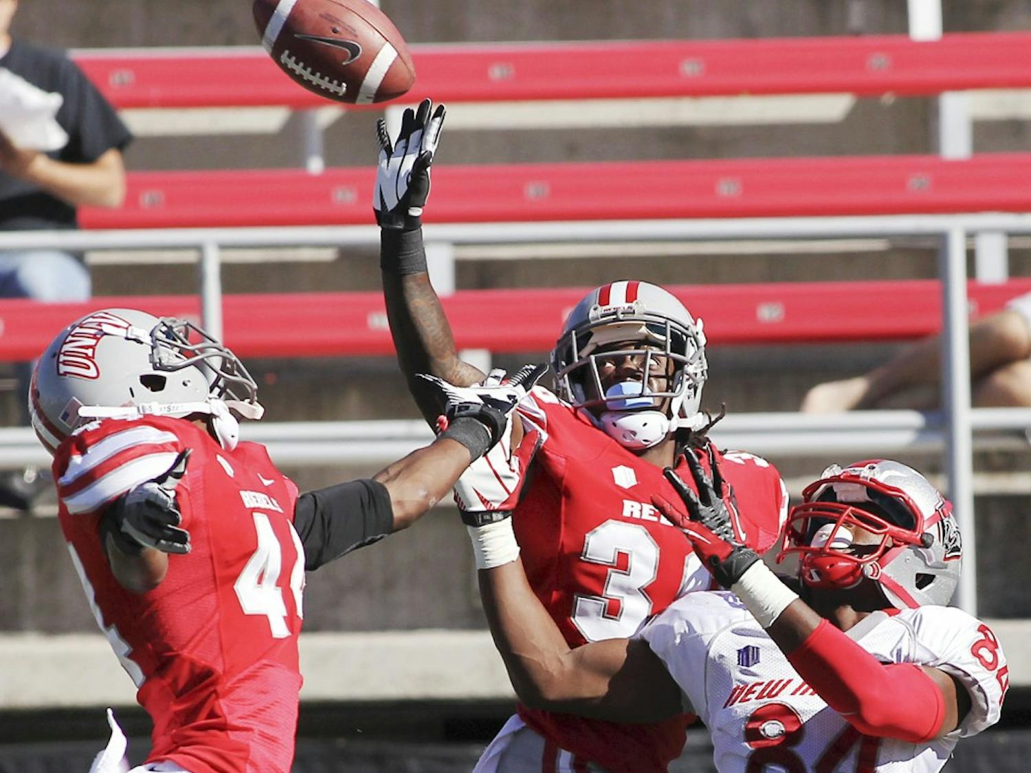 	UNLV defensive backs Sidney Hodge, center, and Kenny Keys defend a pass intended for UNM wide receiver Ty Kirk during the game Saturday in Las Vegas, Nev. The Lobos went on to lose 35-7, their third consecutive loss. 