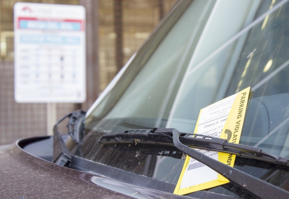 	A parking citation sits on a car outside of George Pearl Hall, where parking is not allowed, on Monday afternoon