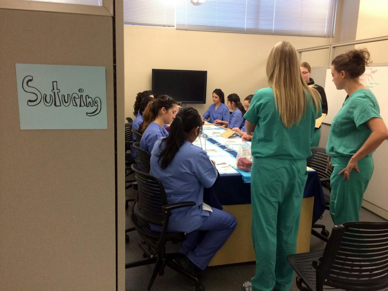Attendees of the 2015 Perry Initiative sit in at a suturing station. The initiative aims to expose high school aged women in trainings and lectures in the engineering and&nbsp;orthopedic&nbsp;fields.