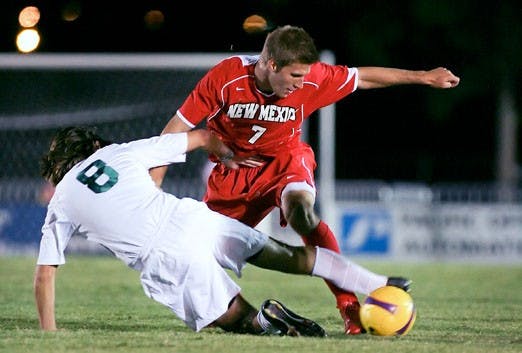 UNM's Justin Davis fights for the ball with Michigan State's Spencer Thompson during Friday's game at the UNM Soccer Complex.