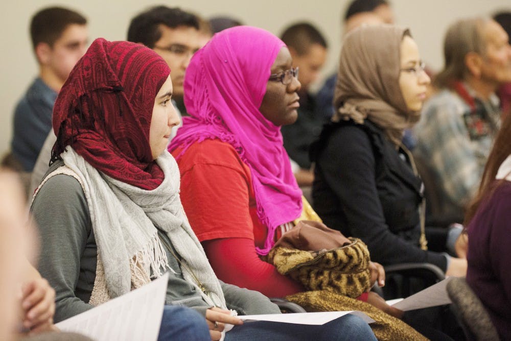 Members of Muslim Student Association, Omkulthoom Qassen, left, Sarah Hassan, middle and Ihsan Wadud, right, attend ASUNMs meeting on Wednesday. ASUNM passed Resolution 6S, which supports Islam in the UNM Community. 
