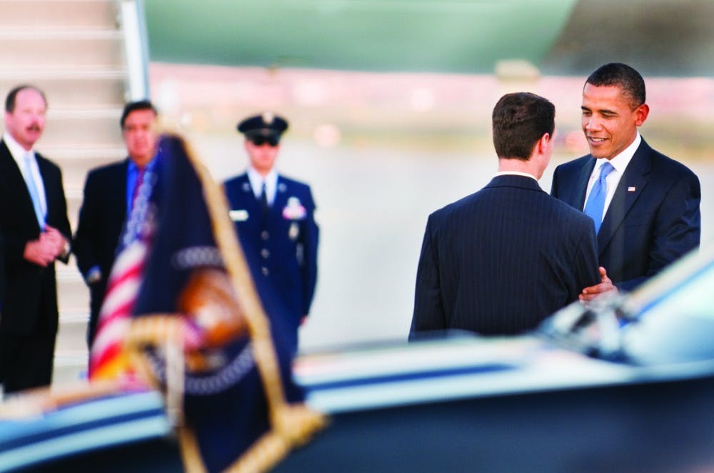 	President Obama chats with NM State Representative Al Park a few minutes after landing at Kirtland Air Force Base on Monday evening.