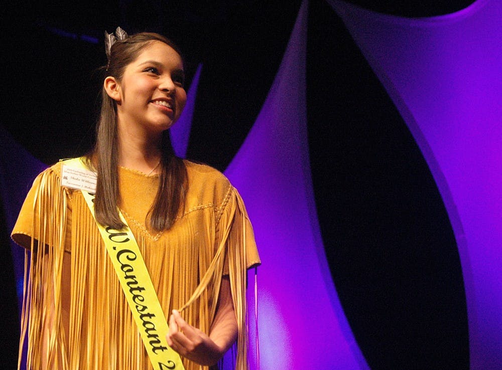 	Shala Williams smiles during a dress rehearsal for the Miss Indian World pageant in the Kiva Auditorium on Thursday. The Gathering of Nations takes place today and Saturday at University Stadium.