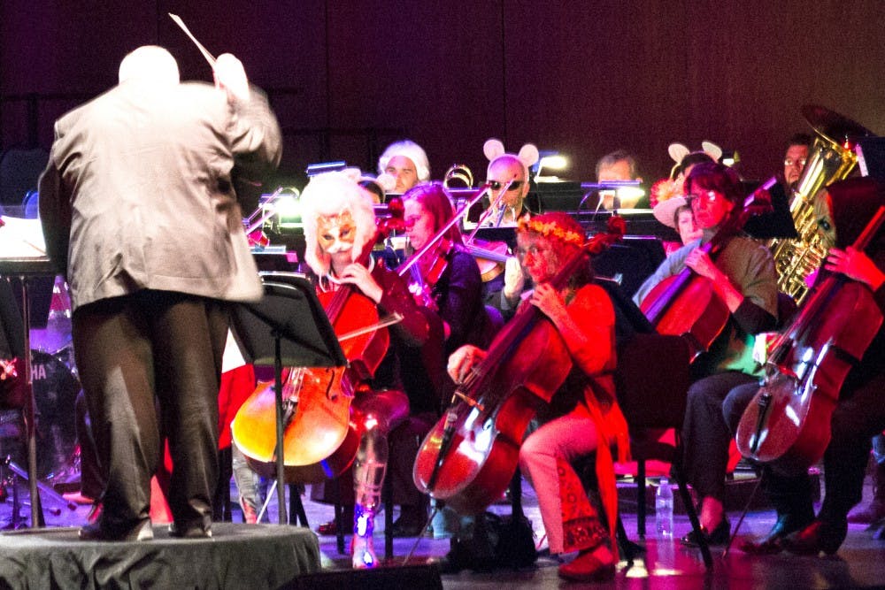 Byron Herrington conducts the New Mexico Philharmonic during Breaking Boo on Saturday evening at Popejoy Hall. The orchestra played Halloween-themed music wearing Halloween costumes throughout the event.