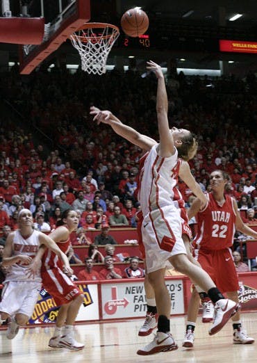 Angela Hartill floats a shot over a Utah defender on Sunday at The Pit. UNM lost a heartbreaker 53-50. 