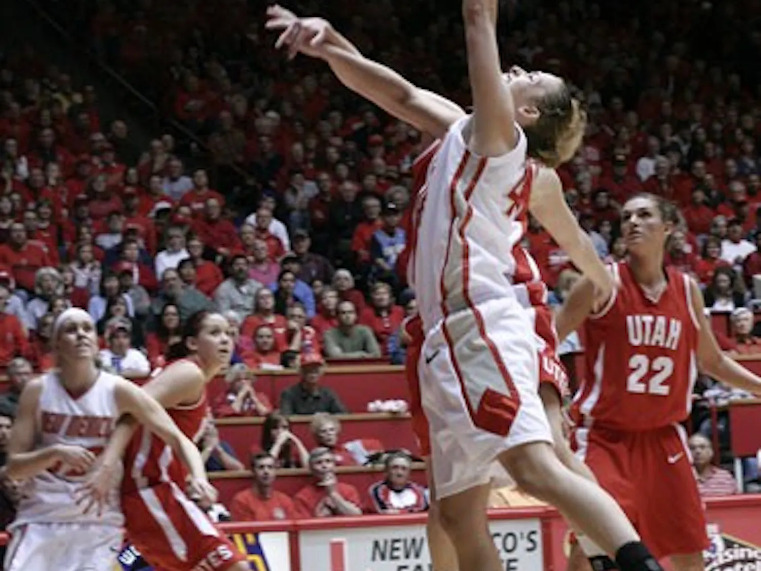 Angela Hartill floats a shot over a Utah defender on Sunday at The Pit. UNM lost a heartbreaker 53-50.