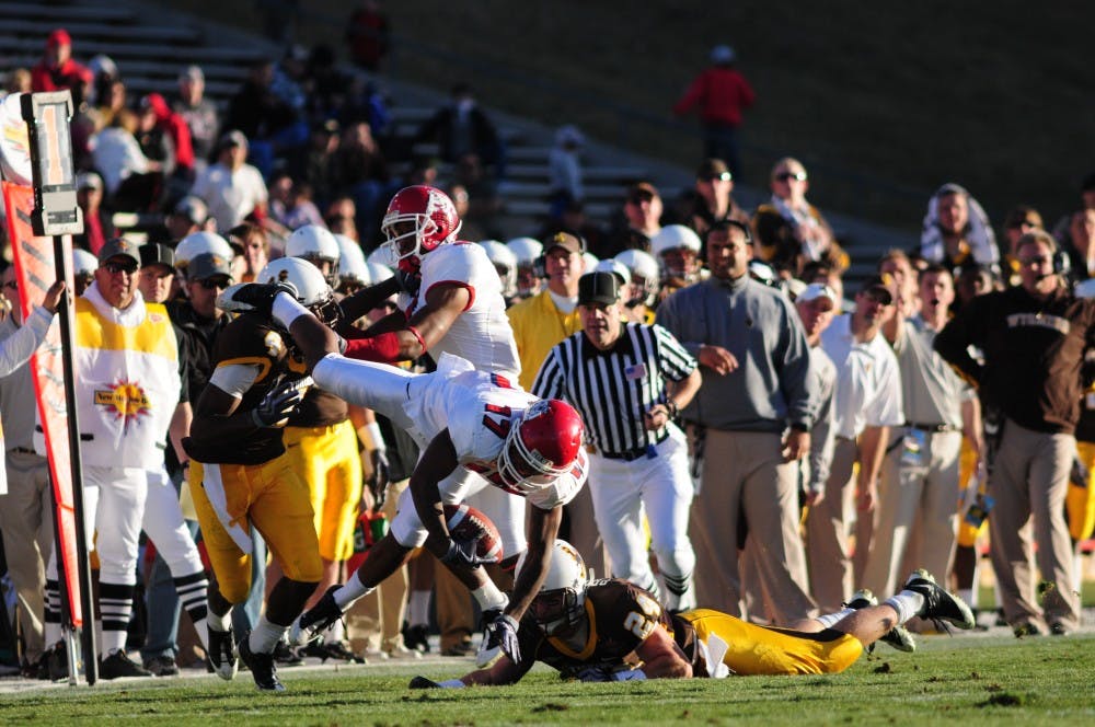 	Fresno State&#8217;s Jamel Hamler is tackled by Wyoming&#8217;s Chris Prosinski during the New Mexico Bowl at University Stadium on Saturday. 