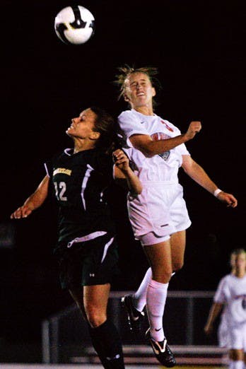 UNM soccer player Jennifer Williams fends off a Baylor defender in Thursday's 2-0 victory at the UNM Soccer Complex. The Lobos improved to 1-1-1.