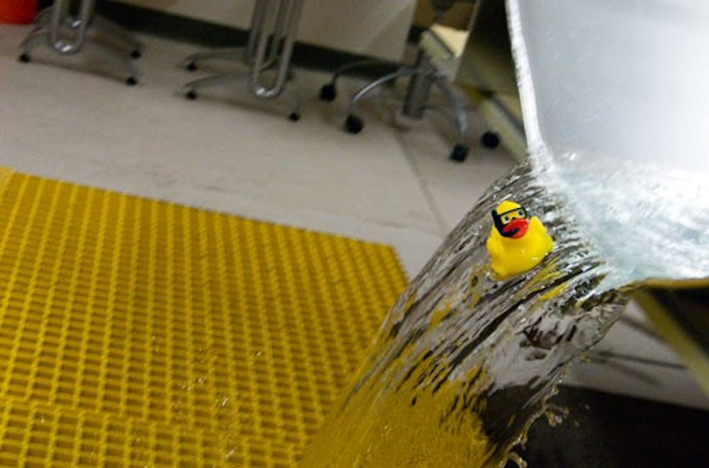 A rubber ducky, representing debris in an arroyo, floats through a model set up in UNM's new hydraulics lab. 