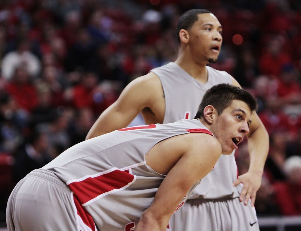 	Roman Martinez crouches down while his teammate Darington Hobson stands in the background during the Mountain West Conference Tournament in Las Vegas, Nev. The two Lobos were honored with national awards this week. 