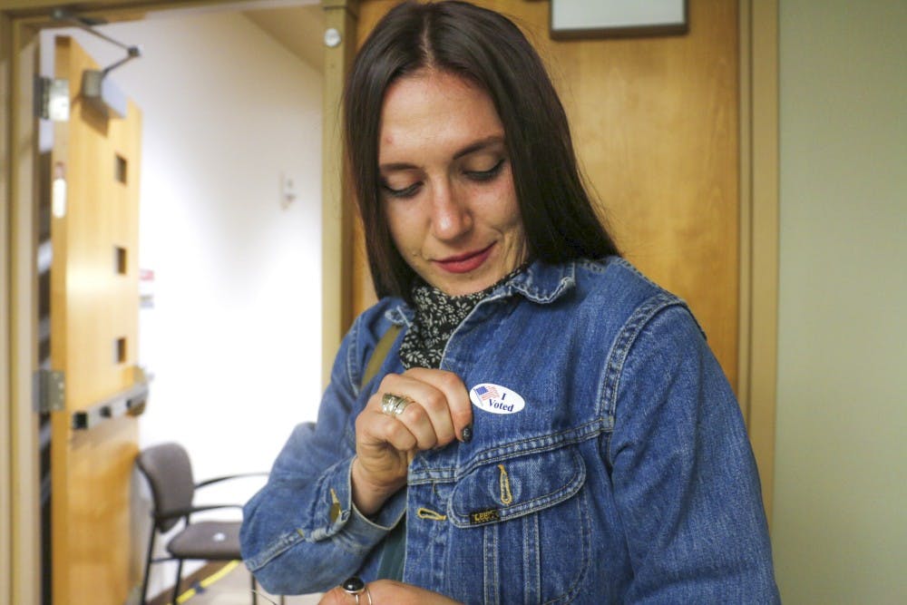 Kelly Finley Davis shows off her voting sticker during an early voting session Friday, Oct. 28, 2016 at the UNM SUB.