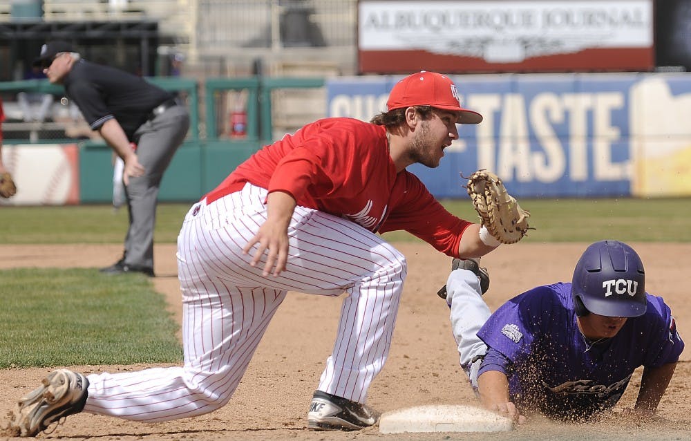UNM first baseman DJ Peterson attempts to tag a TCU runner out at first base. The Lobos beat TCU by 12-7 at Isotopes Park Sunday afternoon. 