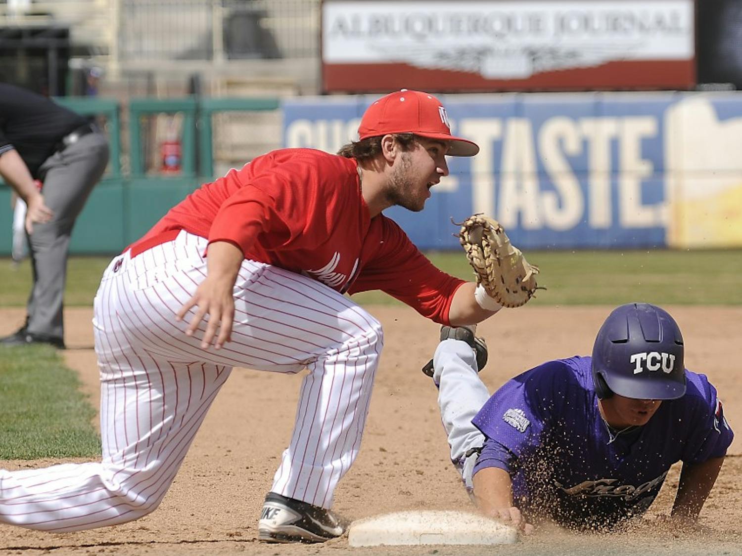 UNM first baseman DJ Peterson attempts to tag a TCU runner out at first base. The Lobos beat TCU by 12-7 at Isotopes Park Sunday afternoon. 