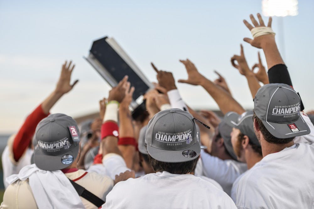 The Lobos cheer and reach towards their 2016 Mountain West Championship trophy after defeating Nevada Saturday, May, 28, 2016 at Santa Ana Star Field.&nbsp;