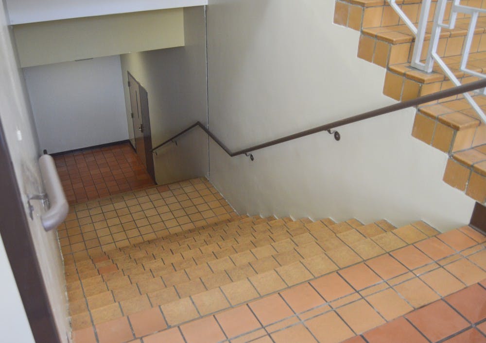 	The restrooms behind the locked door, at the bottom of this stairway at Hokona Hall will be renovated this fall. The new restrooms will feature new plumbing fixtures, partitions, hand dryers and trash receptacles.