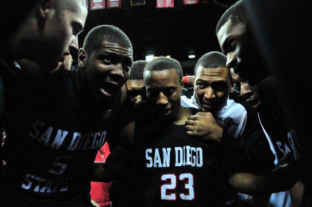 	San Diego State’s Kawhi Leonard emabraces teammate Chase Tapley after the Aztecs claimed the MWC tournament title over UNLV 55-45, on Friday at the Thomas &amp; Mack Center.