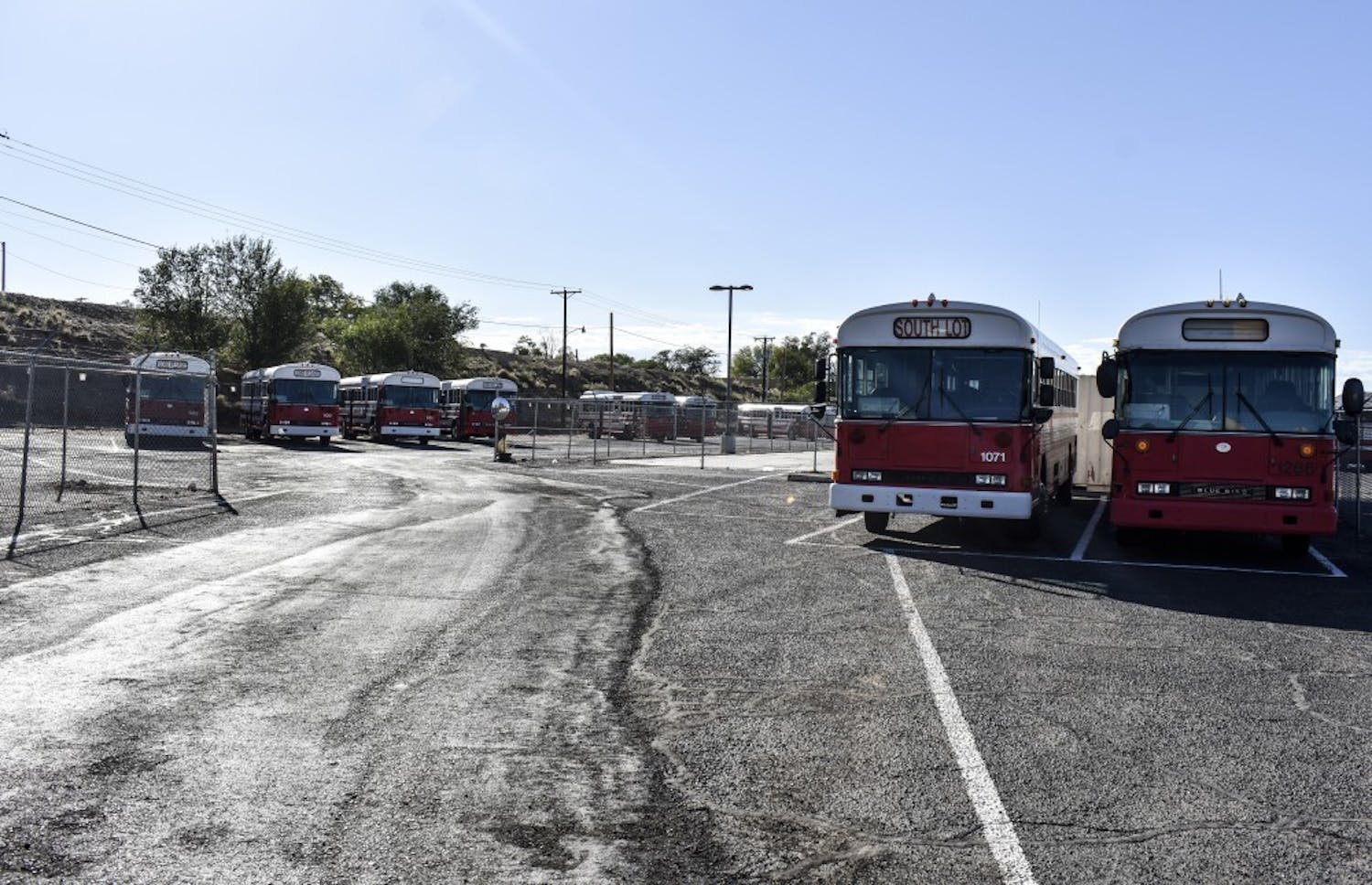 South Lot and Lobo Village shuttles wait to be used in T-lot.