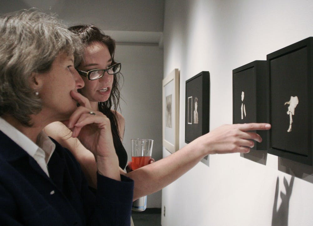 	Student Lauren Carvalho, right, talks with Carrie McGill about her work “Grandmother and Child” at the John Sommers Gallery on Friday. The show, “I Always Know What to Say,” is open through Friday. Check out the multimedia section of DailyLobo.com for a video related to this story.