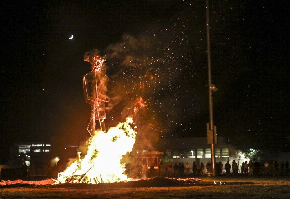 The 25-foot tall Aggie Cowboy effigy burns at the 2018 Red Rally on Johnson Field on Sept. 13, 2018.&nbsp;&nbsp;