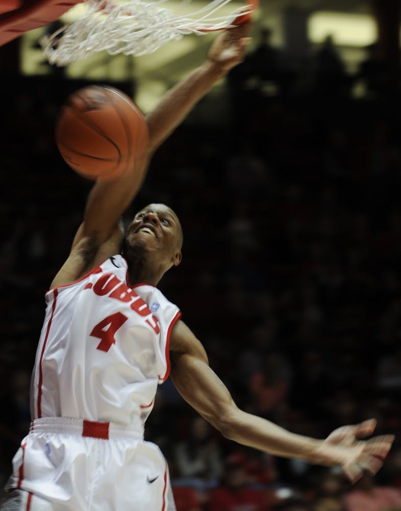 	UNM senior guard Chad Adams dunks during the exhibition game against Victory University on Wednesday in The Pit. UNM beat Victory 105-64.