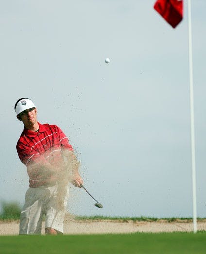 Lobo Brandon Putnam chips out of the sand at UNM's Championship Golf Course on Saturday during the William H. Tucker Intercollegiate Tournament.