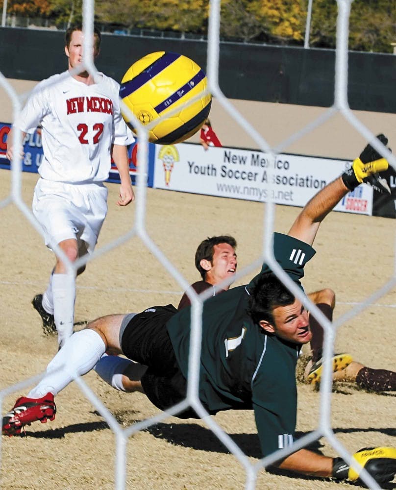 UNM midfielder Stephen Brown watches the ball go past Denver goalkeeper Matt Bredehoft during Sunday's game at the UNM Soccer Complex. The Lobos won 3-0 to clinch the Mountain Pacific Sports Federation title.