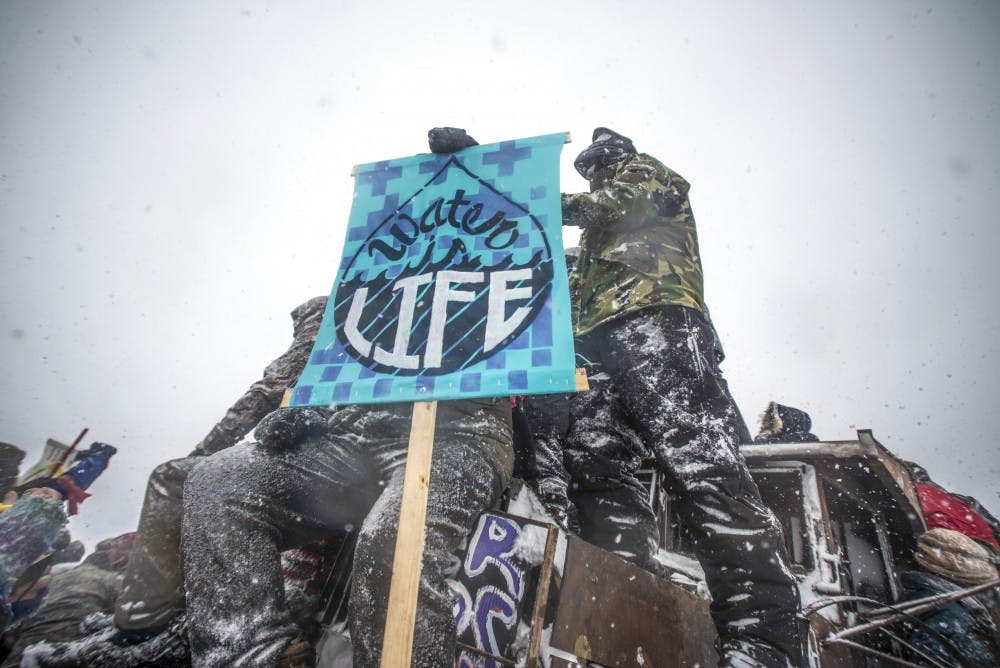 Protestors hold a water is life sign at the front lines near the Oceti Sakowin camp on Standing Rock Reservation Dec. 5, 2016.&nbsp;