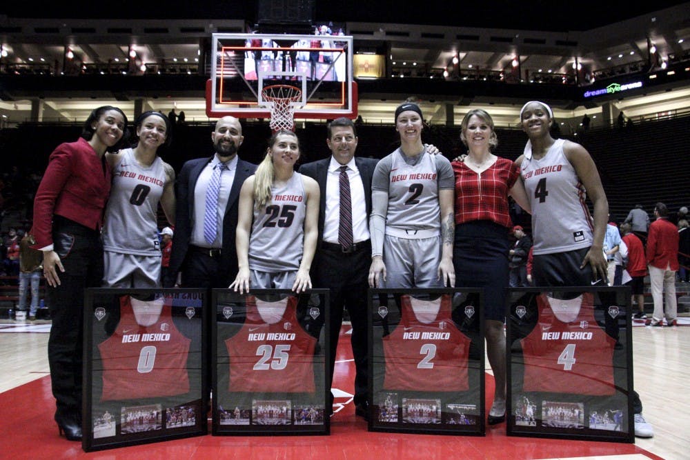 From left to right: Cherise Beynon, Laneah Bryan, Tesha Buck and Alex Lapeyrolerie pose with coaches during senior night on Feb. 27, 2018.