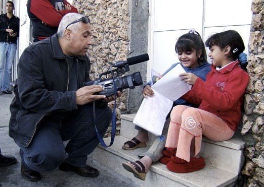 Palestinian journalist Ziad Abbas interviews children at Dheisheh Refugee Camp. Abbas was born and raised in a refugee camp in the Middle East. He will speak at the Albuquerque Mennonite Church on Saturday.