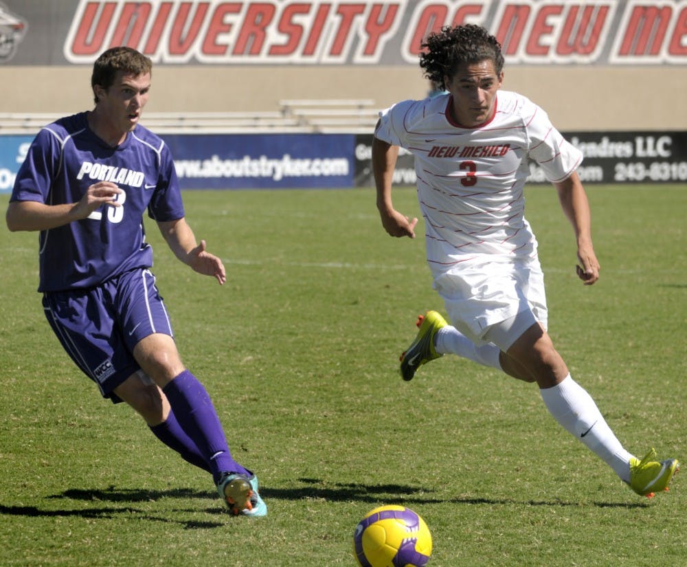 	Portland’s Connor Barbaree and UNM’s Devon Sandoval bolt after a ball at the UNM Soccer Complex on Sunday. Portland knocked off UNM  2-1, the second time it has beat the Lobos in as many years.